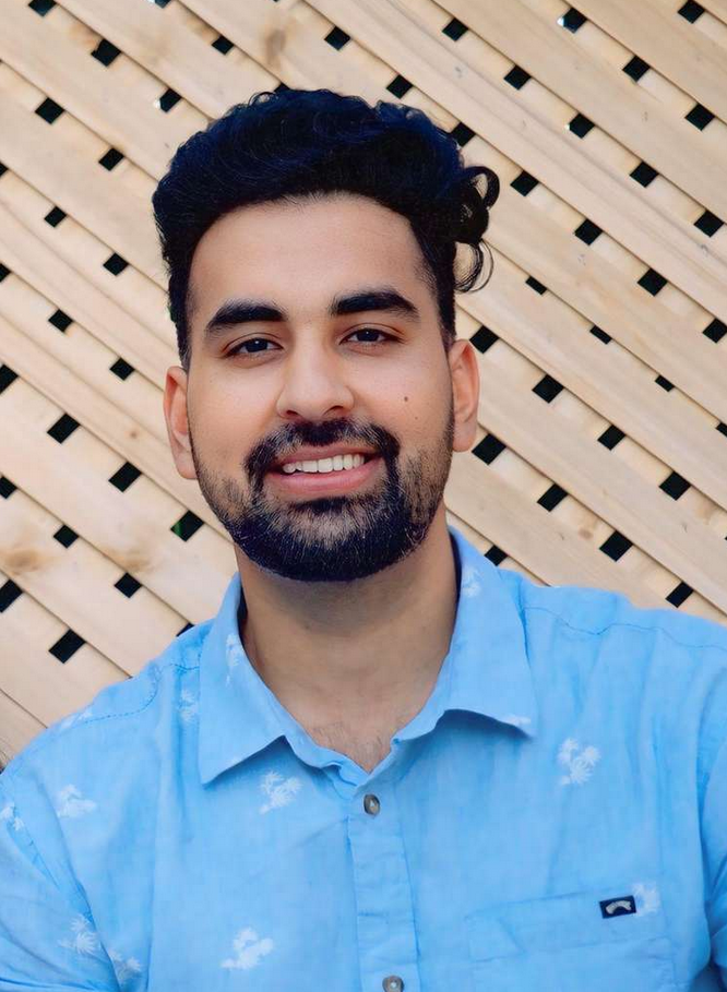 Barry Ruprai smiling in a skyblue shirt